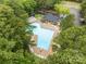 Aerial view of a sparkling pool, sun loungers, and the clubhouse, surrounded by lush greenery at 626 Trail Ridge Rd, Matthews, NC 28105