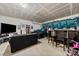 Finished basement featuring a large tv, ample seating, and unique decor, perfect for entertainment and relaxation at 6510 Nathan Dr # 78, Charlotte, NC 28269