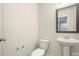 Cozy half bathroom featuring a pedestal sink and decorative mirror at 6510 Nathan Dr # 78, Charlotte, NC 28269