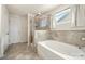 Modern bathroom featuring a soaking tub, a glass-enclosed shower, and stylish tile work, providing a spa-like experience at 6510 Nathan Dr # 78, Charlotte, NC 28269