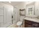 Bright bathroom with shower, granite vanity, and decorative shelving at 6510 Nathan Dr # 78, Charlotte, NC 28269
