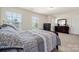 Bedroom features natural light, two dressers, a soft carpet, and a light-colored interior at 6510 Nathan Dr # 78, Charlotte, NC 28269