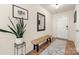 Bright entryway featuring hardwood floors, a wooden bench, and stylish decor at 6510 Nathan Dr # 78, Charlotte, NC 28269