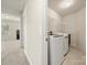 Functional laundry room with modern washer and dryer, a wire shelf, and convenient access from the hallway at 6510 Nathan Dr # 78, Charlotte, NC 28269