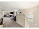 Bright loft area with plush carpet, modern lighting, and an open view to the Primary bedroom, creating a cozy and inviting space at 6510 Nathan Dr # 78, Charlotte, NC 28269