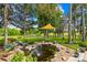 Backyard pond with water feature and garden, complemented by lush green lawn at 738 Rocky Hollow Trl, Clover, SC 29710