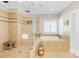 Luxurious bathroom features a soaking tub, glass-enclosed shower, and warm-toned tile at 738 Rocky Hollow Trl, Clover, SC 29710