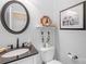 Well-lit bathroom featuring a round mirror, black hardware, and white shiplap walls at 738 Rocky Hollow Trl, Clover, SC 29710