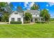 Charming white farmhouse with black shutters and well-manicured front lawn at 738 Rocky Hollow Trl, Clover, SC 29710