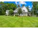 Attractive two-story home with a welcoming wrap-around porch and vibrant green lawn at 738 Rocky Hollow Trl, Clover, SC 29710