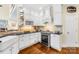 Charming kitchen with white cabinets, stainless steel oven, hardwood floors, and decorative tile backsplash at 738 Rocky Hollow Trl, Clover, SC 29710