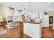 Open-concept kitchen with living room view; kitchen island, bar seating, and stairs to second floor at 738 Rocky Hollow Trl, Clover, SC 29710