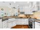 Bright kitchen featuring white cabinetry, dark countertops, stainless steel appliances, and hardwood floors at 738 Rocky Hollow Trl, Clover, SC 29710