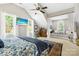 Bright main bedroom with vaulted ceilings, ceiling fan, and large windows with window seat at 738 Rocky Hollow Trl, Clover, SC 29710