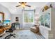 Bright home office featuring a large window, wooden desk, comfortable chair, and built-in bookcase at 738 Rocky Hollow Trl, Clover, SC 29710