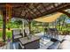 Covered patio with comfortable seating, ceiling fan, and view of backyard pond at 738 Rocky Hollow Trl, Clover, SC 29710