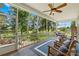 Relaxing screened porch featuring comfortable seating and views of the lush backyard and neighboring field at 738 Rocky Hollow Trl, Clover, SC 29710