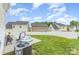 View of backyard featuring a small pool, green grass, and a white fence at 8005 Stevie Oaks Ln, Charlotte, NC 28215