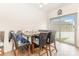 Bright dining area featuring wood floors, a modern table, and sliding glass doors to the exterior at 8005 Stevie Oaks Ln, Charlotte, NC 28215
