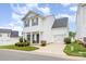Charming two-story home with a garage, covered porch and a well-manicured lawn at 8005 Stevie Oaks Ln, Charlotte, NC 28215