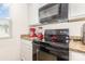 Kitchen with granite countertops, black appliances, and white cabinets at 8005 Stevie Oaks Ln, Charlotte, NC 28215