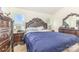 Bedroom with dark wood furniture, a large bed, and bright windows at 8005 Stevie Oaks Ln, Charlotte, NC 28215