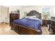 Bedroom with dark wood furniture, a large bed, and bright windows at 8005 Stevie Oaks Ln, Charlotte, NC 28215