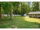Large, well-maintained backyard featuring a shed, screened in porch, and mature trees, perfect for outdoor living at 8418 Knollwood Cir, Charlotte, NC 28213