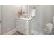 Charming bathroom featuring a single sink vanity, decorative mirror, and modern finishes at 8418 Knollwood Cir, Charlotte, NC 28213