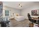 Clean bedroom provides a ceiling fan, music keyboard, work station, and natural lighting at 8418 Knollwood Cir, Charlotte, NC 28213