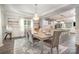 Open dining room with hardwood floors, chandelier, and view to the kitchen and living areas at 8418 Knollwood Cir, Charlotte, NC 28213