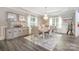 Bright dining room featuring hardwood floors, a chandelier, and neutral decor at 8418 Knollwood Cir, Charlotte, NC 28213