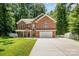 Charming brick home featuring a manicured lawn, mature trees, and a spacious driveway at 8418 Knollwood Cir, Charlotte, NC 28213