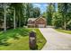 Inviting brick home with a long driveway, mature trees, and lush green lawn at 8418 Knollwood Cir, Charlotte, NC 28213
