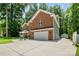 Brick home featuring an attached two car garage, extended driveway and well maintained yard at 8418 Knollwood Cir, Charlotte, NC 28213