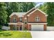 Charming two-story brick home featuring a manicured lawn, a two-car garage, and a welcoming front porch at 8418 Knollwood Cir, Charlotte, NC 28213