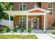 Inviting front porch with decorative wreath, seating area, and meticulously maintained landscaping at 8418 Knollwood Cir, Charlotte, NC 28213