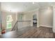 Bright hallway featuring hardwood floors, large windows, and chandelier at 8418 Knollwood Cir, Charlotte, NC 28213