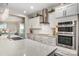 The kitchen features white cabinetry, stainless steel appliances, quartz countertop, and undermount sink at 8418 Knollwood Cir, Charlotte, NC 28213