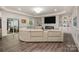 Open living room featuring a white leather sofa with views of the backyard at 8418 Knollwood Cir, Charlotte, NC 28213