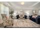 Elegant living room featuring hardwood floors, coffered ceiling, decorative rug and furniture at 8418 Knollwood Cir, Charlotte, NC 28213
