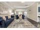 Open-concept living room featuring hardwood floors, coffered ceiling, and neutral decor at 8418 Knollwood Cir, Charlotte, NC 28213