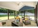 Relaxing sun room boasts screened windows with outdoor seating and dining areas at 8418 Knollwood Cir, Charlotte, NC 28213