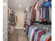 A large walk-in closet with ample hanging storage and wood flooring at 8418 Knollwood Cir, Charlotte, NC 28213