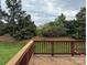 Wooden deck overlooking a lush backyard with mature trees and greenery, creating a peaceful outdoor retreat at 8620 Rolling Fields Rd, Charlotte, NC 28227