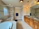 Bright bathroom with large tub, shower, and double vanity with granite countertop at 8620 Rolling Fields Rd, Charlotte, NC 28227