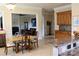 Bright breakfast nook with tile floors, breakfast table, and views into the living room and kitchen at 8620 Rolling Fields Rd, Charlotte, NC 28227