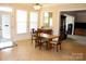 Bright dining area features a stylish light fixture, large windows, and access to a large living space at 8620 Rolling Fields Rd, Charlotte, NC 28227