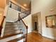 Grand foyer with hardwood floors, staircase with iron railing, and high ceilings at 8620 Rolling Fields Rd, Charlotte, NC 28227