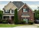 Charming brick two-story home with manicured lawn, black shutters, and mature trees at 8620 Rolling Fields Rd, Charlotte, NC 28227